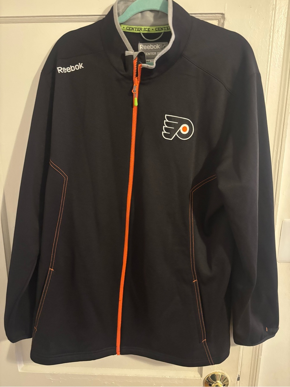 Reebok Black Jacket with Orange Zip and Logo Accent
